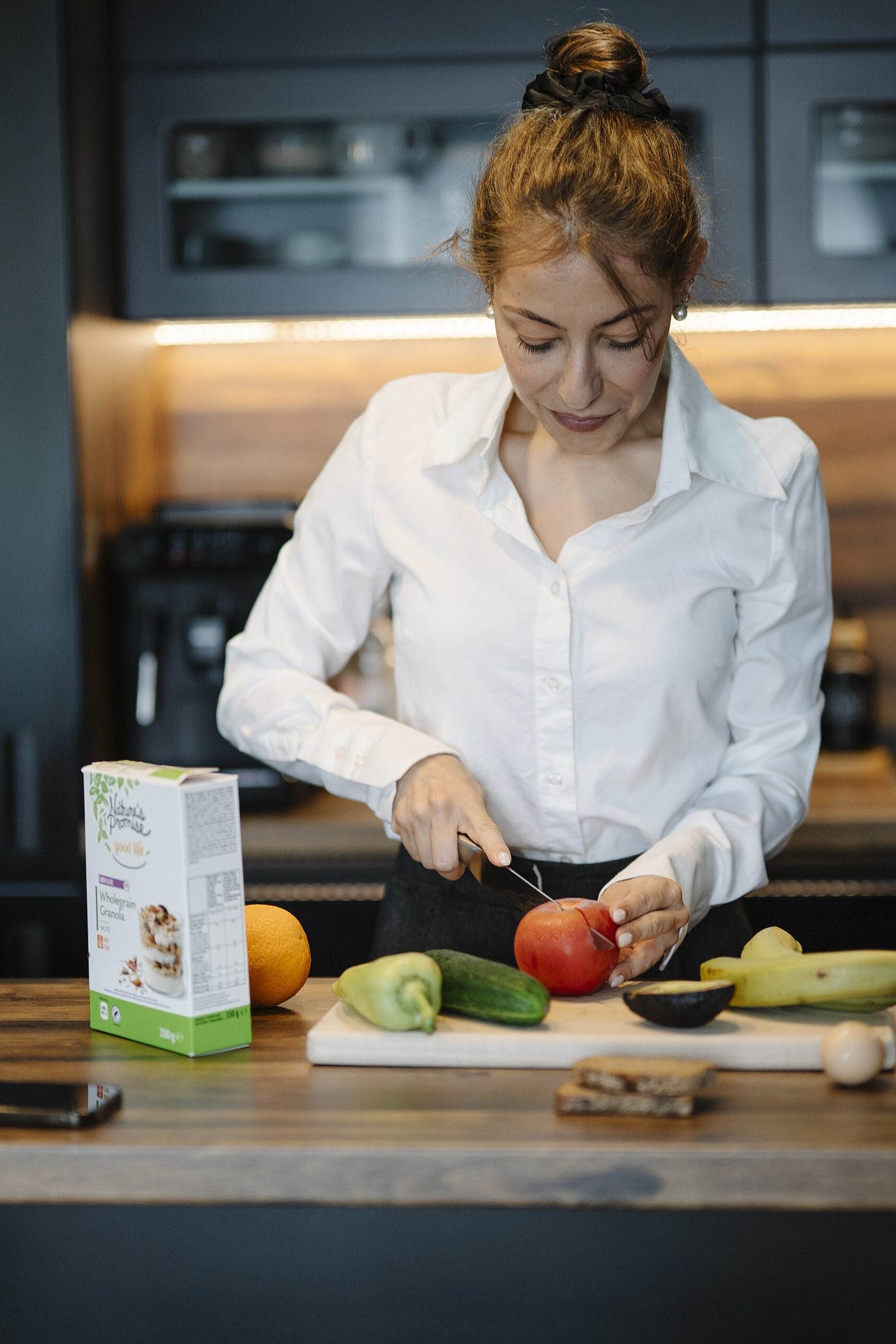 Maya Ellison cooking in a bright white kitchen