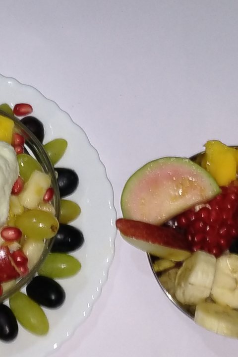 A breakfast plate of berries, banana, citrus, and avocado